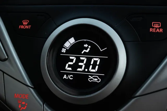 A vehicle climate control dial set to air conditioning