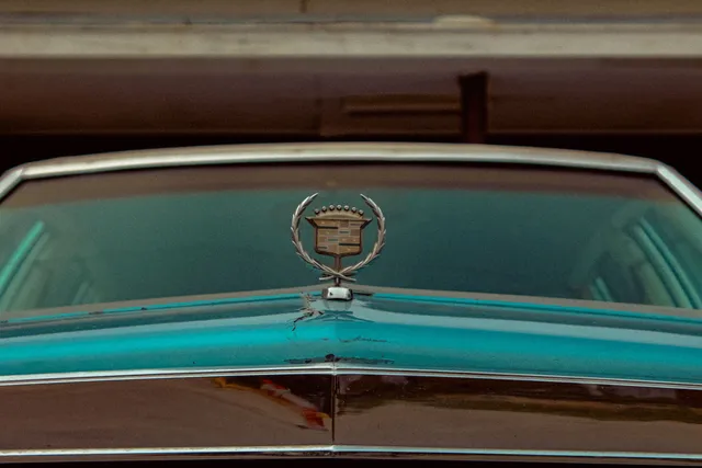 The hood ornament of a classic Cadillac