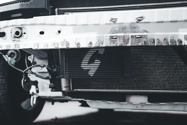 A radiator and condenser core at the front of a vehicle