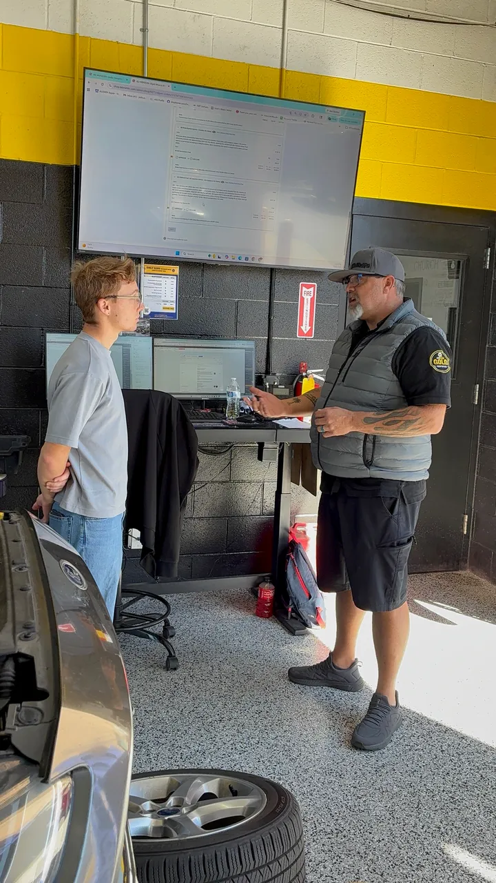 A McNeil's technician walking a customer through inspection findings in the ID Bay