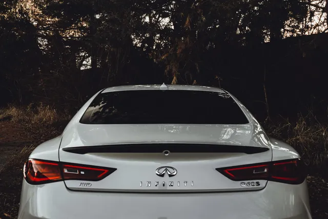 The rear of a white Infiniti sedan