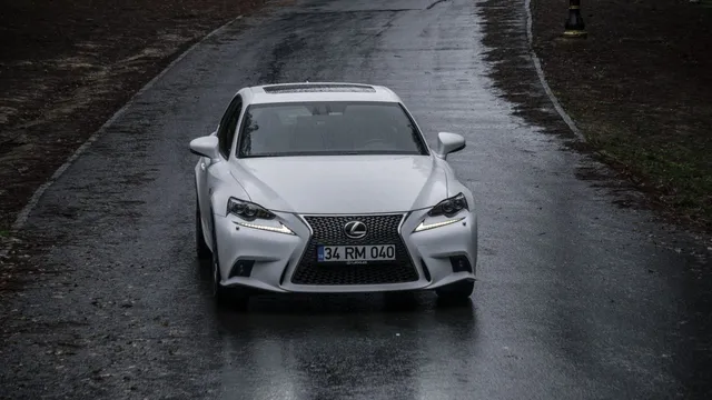 A white Lexus sedan on a road