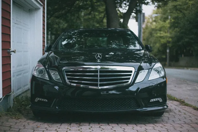 A black Mercedes-Benz sedan photographed from the front