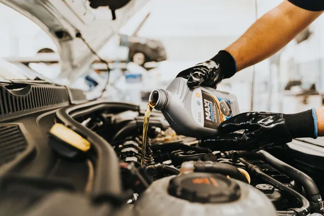 Fresh engine oil being poured into an engine