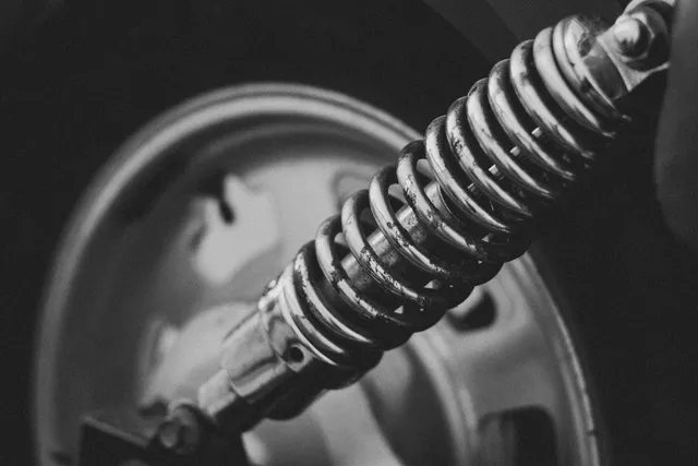 A coilover shock absorber mounted behind a road wheel