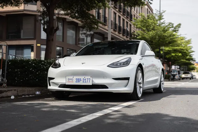 A white Tesla Model 3 on a street