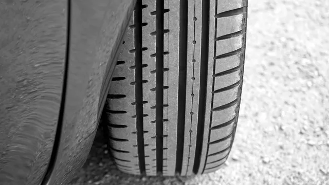 Close crop of the tread pattern on a car tire